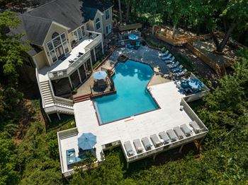 Woods surround the clubhouse, pool and pool deck.